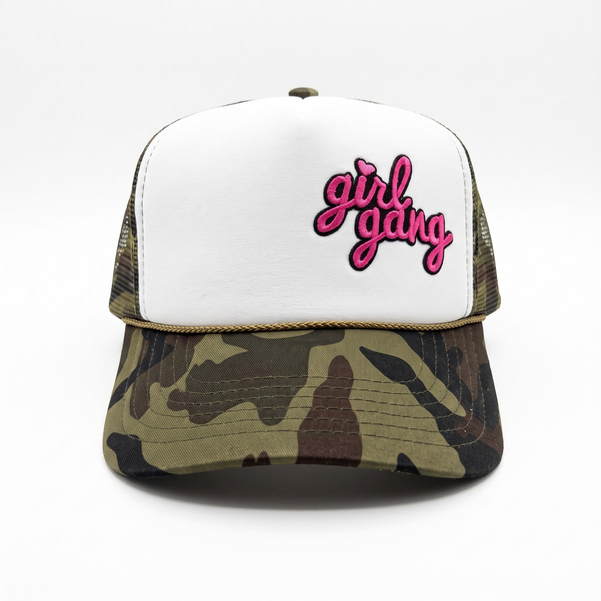 A white and camouflage trucker hat with pink embroidered 'girl gang' text on the front, shown against a plain white background.