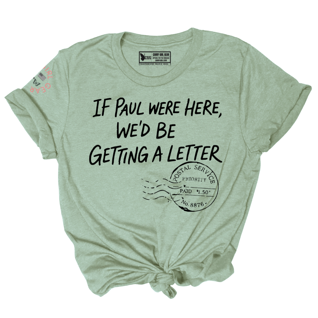 A light sage green heather t-shirt with a distressed black graphic that reads 'IF PAUL WERE HERE, WE'D BE GETTING A LETTER' above a postage stamp illustration. The t-shirt is styled with a knot at the bottom hem and a tie at the collar, shown flat on a white background.