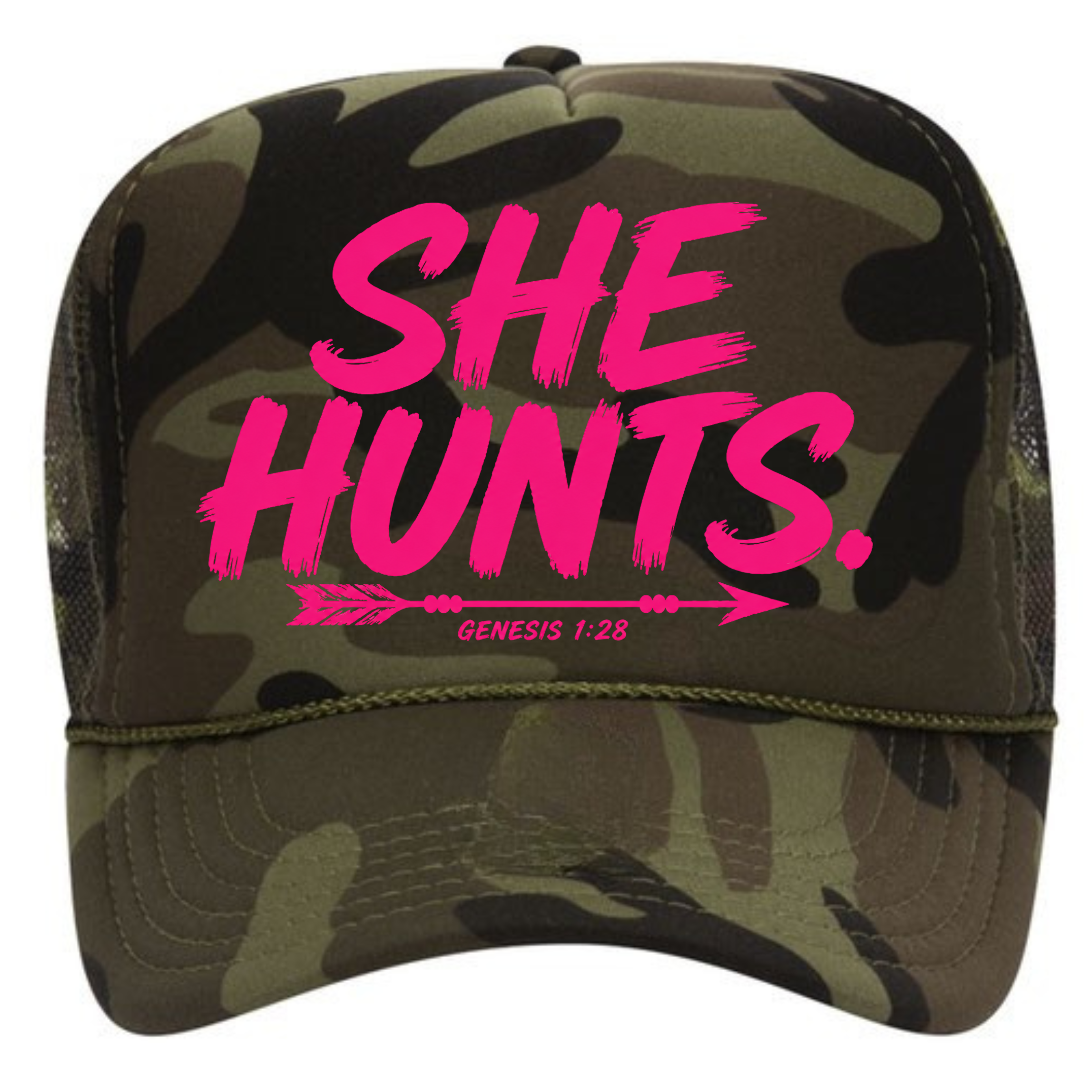 A camouflage trucker hat with bright pink text reading 'SHE HUNTS.' and smaller text 'GENESIS 1:28' with an arrow graphic, shown on a plain white background.