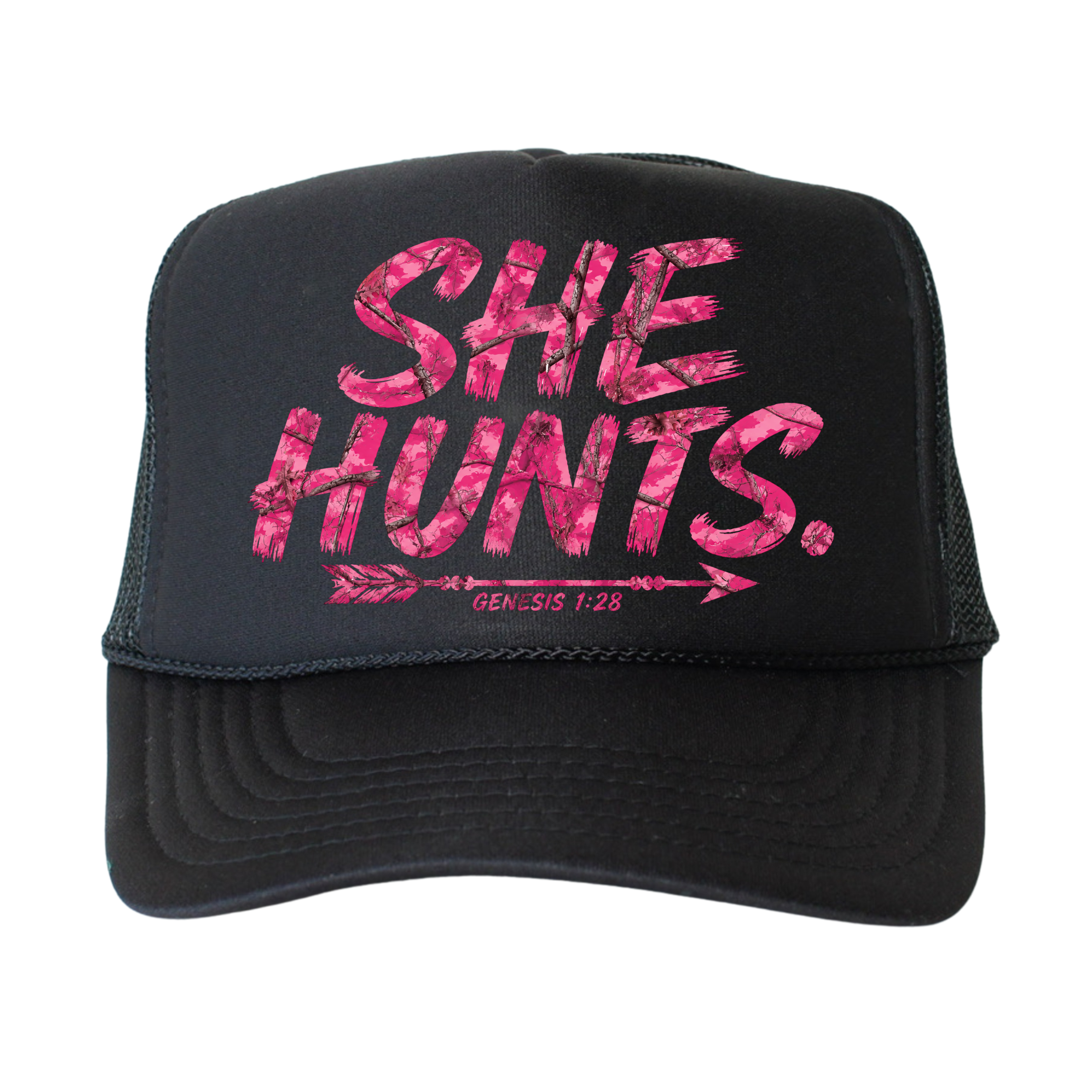 A black trucker hat with pink camouflage-style lettering that reads 'SHE HUNTS.' and a smaller 'GENESIS 1:28' line under an arrow graphic, shown on a plain white background.